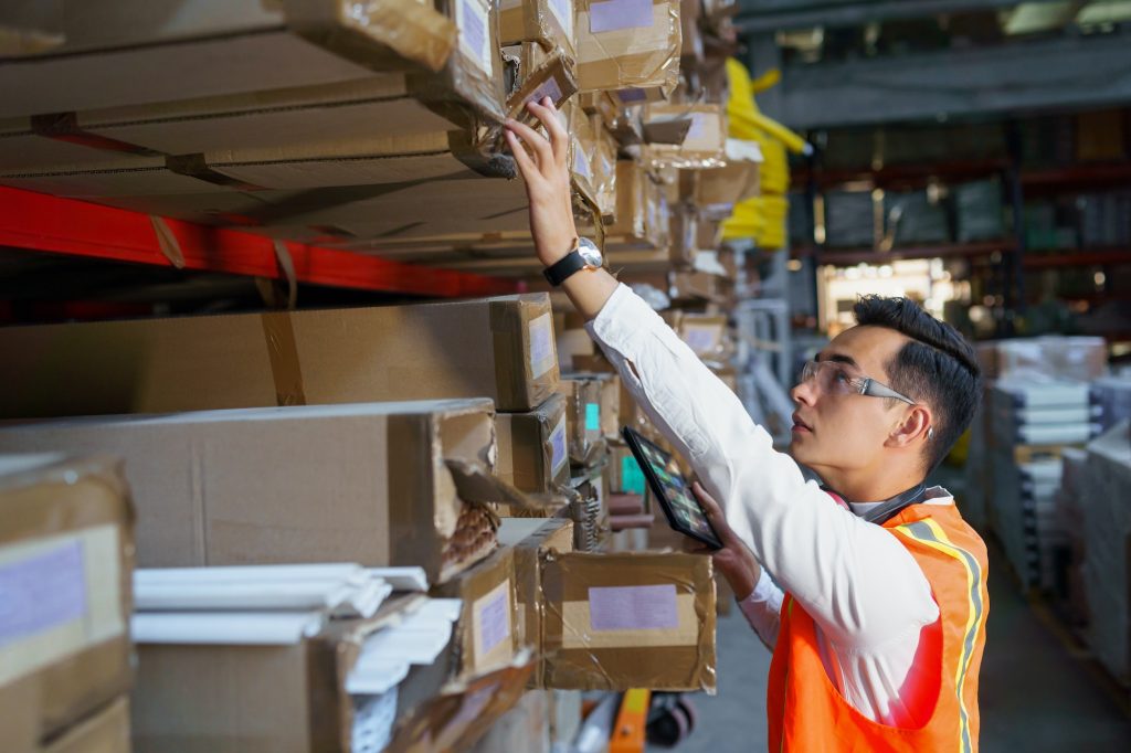 Warehouse worker looking for goods on the shelves